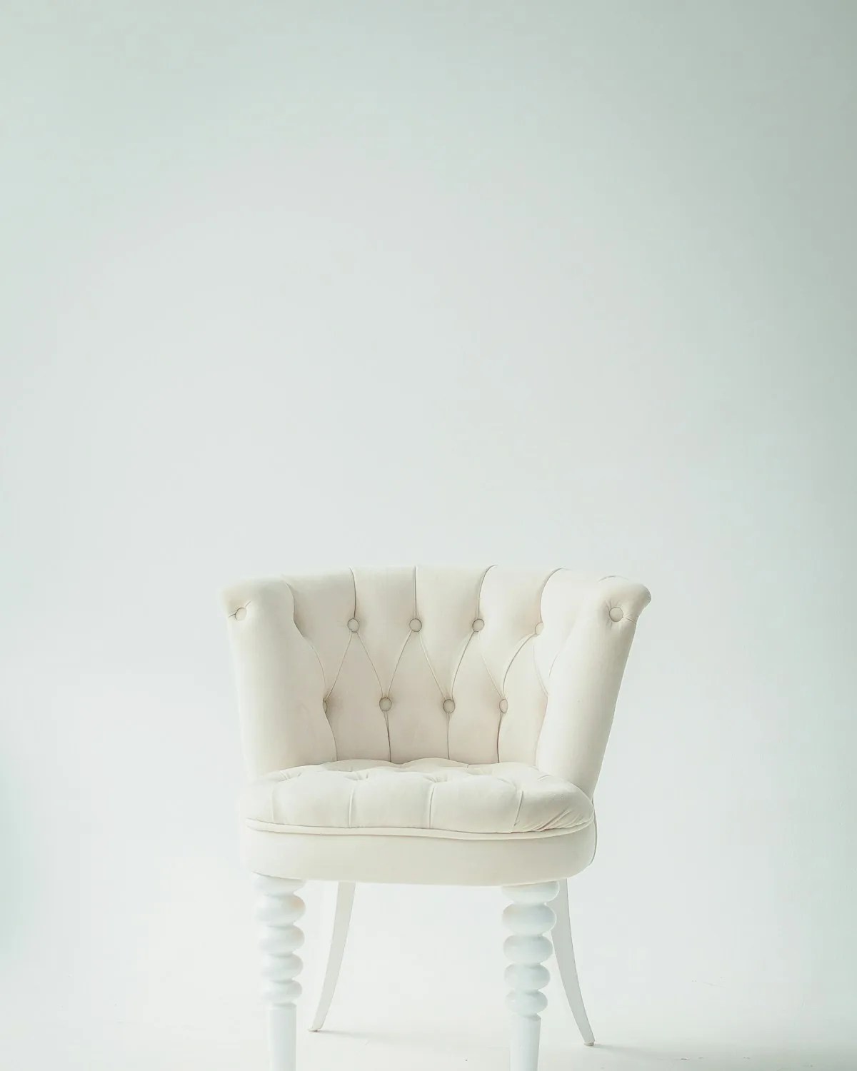Atelier Lounge Chair in ivory bouclé against a soft green wall