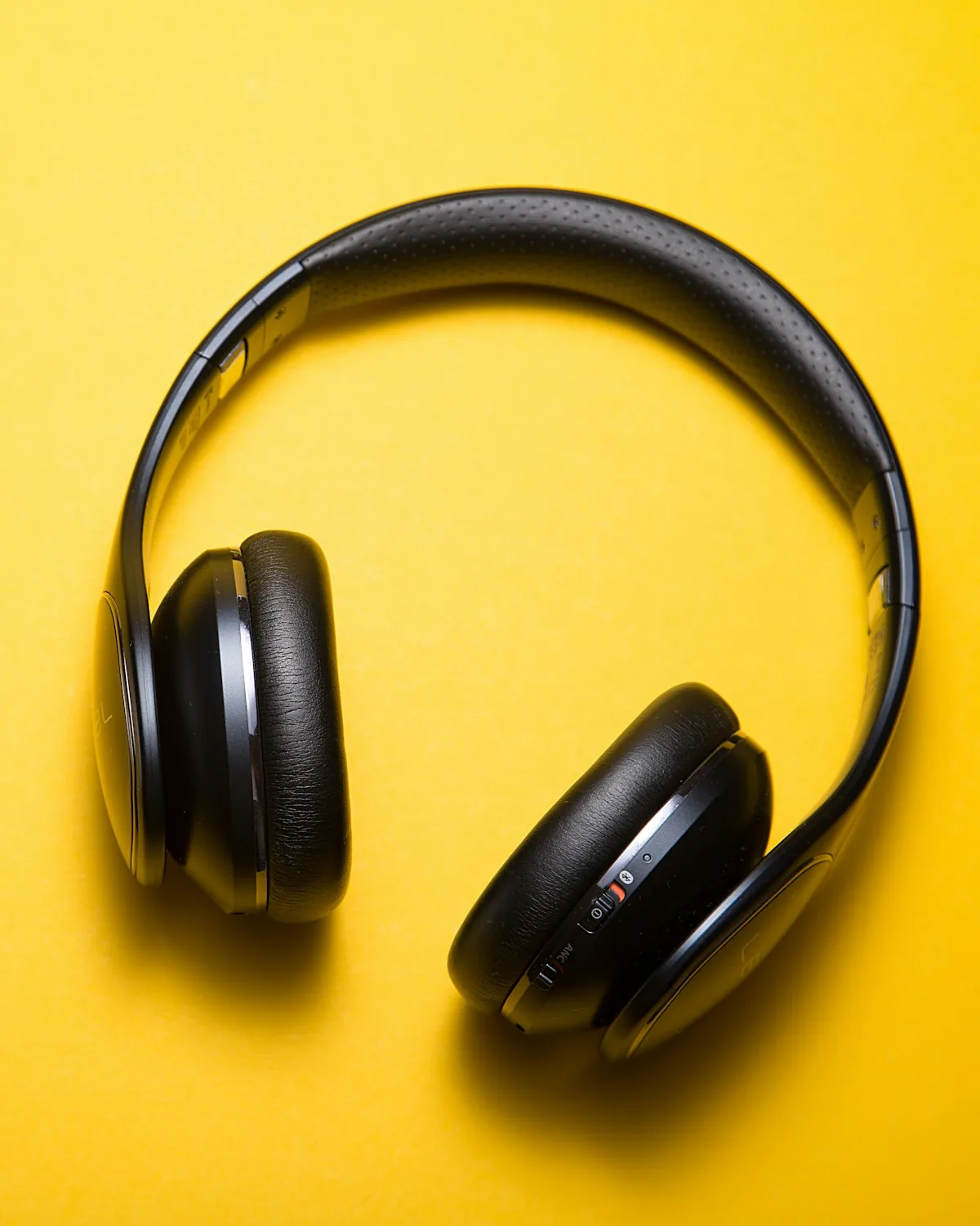 Studio Headphones in black on a warm yellow background